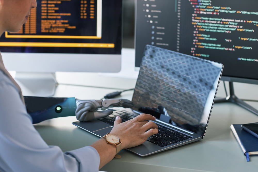 software-engineer-coding-at-desk-with-robotic-arm-2026-01-08-06-46-58-utc.jpg